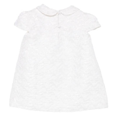 Baby girl dress in white with a textured pattern, short sleeves, and a Peter Pan collar, featuring a button closure at the back.
