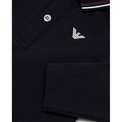 Navy long sleeve polo shirt for boys featuring a white emblem and striped collar.