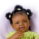 Realistic Ashton Drake Alexis Baby Doll with curly black hair, green hair accessories, and a smiling expression, wearing a green outfit.
