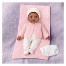 Lifelike Ashton Drake Tiny Miracles doll, 10 Little Kiara, dressed in pink outfit with bow, resting on a pink blanket with a diaper beside.