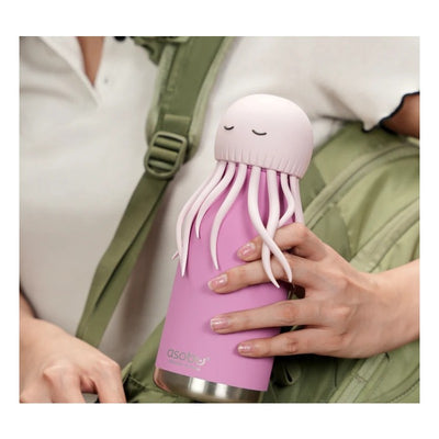 Asobu stainless steel bottle with a pink jellyfish silicone head, held in a hand, featuring whimsical tentacle design.