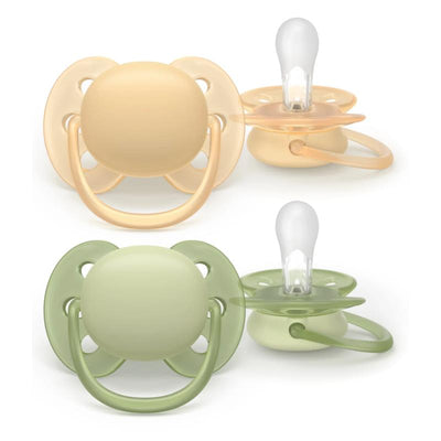 Avent 2Pk Ultra Soft Pacifier for ages 6-18 months in beige and pastel warm green colors, featuring a rounded shape and soft silicone nipples.