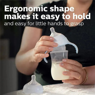 Teal Avent baby bottle designed for easy gripping and use by infants, held by a person with visible cream-colored milk inside.