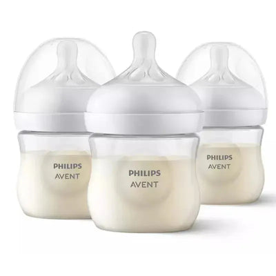 Three clear Philips Avent baby bottles, each with a natural response nipple, holding milk, 4 oz capacity.