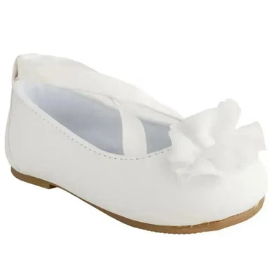 White baby girl shoes with a strap and a decorative ruffled flower detail on the front.