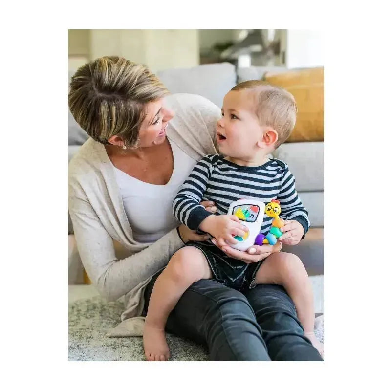 Mom and toddler enjoying the Baby Einstein Take Along Tunes Musical Toy, featuring colorful buttons and a friendly animal figure.