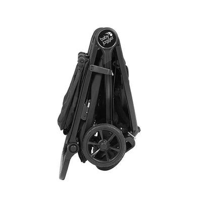 Black Baby Jogger City Mini GT2 Double Stroller in a folded position, showcasing its compact design and wheels.