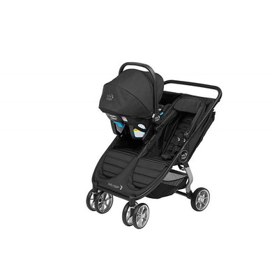 Graco Baby Jogger car seat adapter attached to a City Mini 2 double stroller in black, featuring adjustable canopies and large wheels.