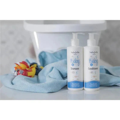 Baby Jolie Bath Gift Set featuring shampoo and conditioner bottles beside a soft blue towel and rubber ducks.