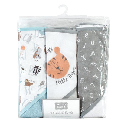 Three unisex baby hooded towels from Hudson Baby, featuring animal motifs and an alphabet design in a clear packaging.