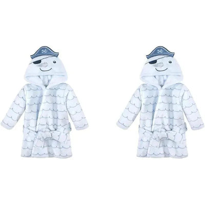Unisex baby plush bathrobe featuring a narwhal design with a smiling face and pirate hat, in white with wave patterns.