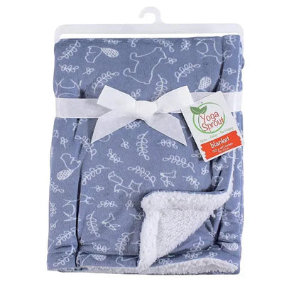 Mink blanket from Yoga Sprout featuring a forest-themed pattern and cozy sherpa backing, tied with a ribbon.
