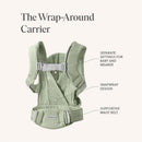 Cream Babybjorn Baby Carrier with a snapwrap design, featuring separate settings for baby and wearer and a supportive waist belt.