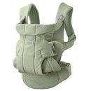 Babybjorn Baby Carrier in light green, featuring a padded design with adjustable straps and a mesh panel for comfort.
