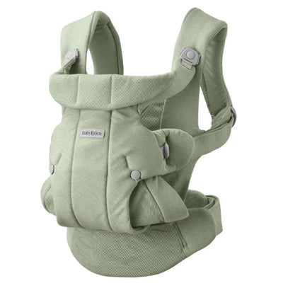 Babybjorn Baby Carrier in light green, featuring a padded design with adjustable straps and a mesh panel for comfort.