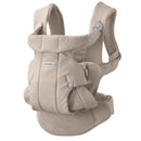 Babybjörn Baby Carrier Hold in sand gray, featuring padded shoulder straps and adjustable buckles for comfortable carrying.