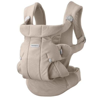 Babybjörn Baby Carrier Hold in sand gray, featuring padded shoulder straps and adjustable buckles for comfortable carrying.