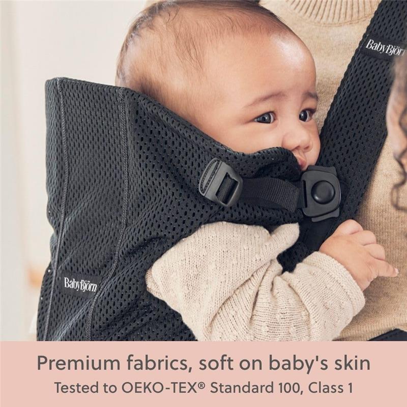 Babybjorn Baby Carrier Mini in black 3D mesh, showing a baby comfortably nestled, highlighting soft, breathable fabric.