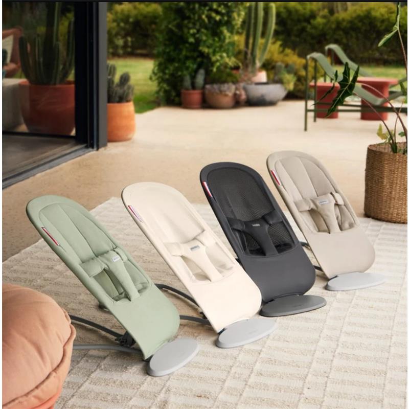 Babybjorn Bouncer Begin in Light Green displayed with three other color options on a patio setting.
