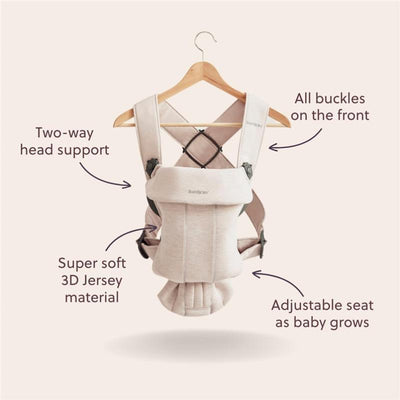 Babybjorn Carrier Mini in Light Beige features two-way head support, adjustable seat, and soft 3D Jersey material, displayed on a hanger.