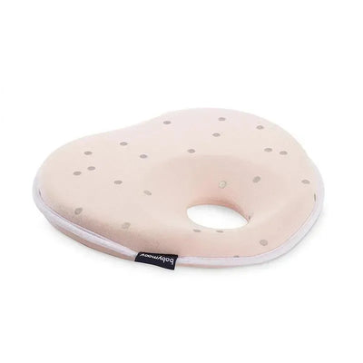 Babymoov Lovenest in pink with polka dots, designed for head support in infants, featuring a circular cutout.