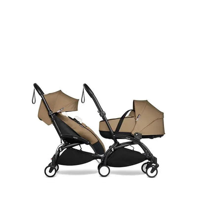 Babyzen Yoyo footmuff in Toffee color, displayed alongside a stroller, featuring a sleek design and comfortable fabric.