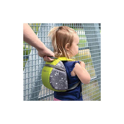 Toddler wearing a Bbluv Päk lime and grey backpack with a rein, held by an adult on a bridge.