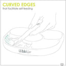 Yümi 4-section silicone plate in pink, with a hand holding a spoon, highlighting curved edges for self-feeding.