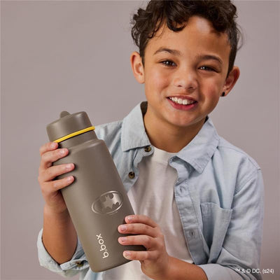 34Oz Batman triple insulated kids water bottle with stainless steel straw, held by a smiling boy wearing a light blue shirt.