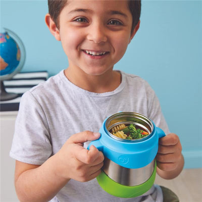 Smiling boy holding a blue and green Bbox insulated food jar filled with pasta and vegetables.