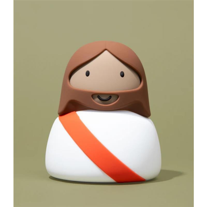 Light-up night light shaped like a cartoonish figure of Jesus with a brown beard and a white robe, featuring a red sash.