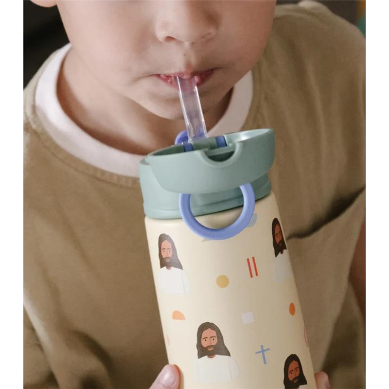 Child sipping from a Be A Heart Jesus Stainless Steel Water Bottle, featuring colorful illustrations of Jesus on a yellow background.