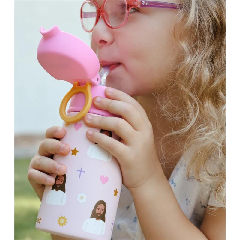 Child sipping from a pink Jesus-themed stainless steel water bottle with cute character designs and a flip-top lid.