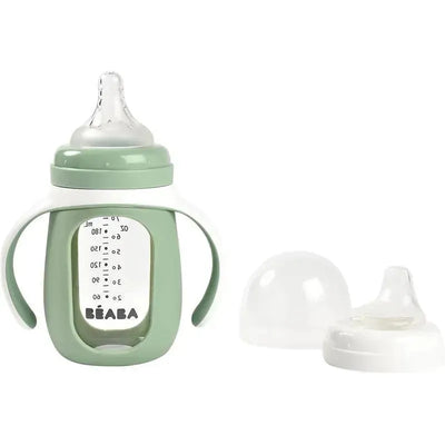 2-in-1 glass training cup by Beaba in sage green, features two handles and includes removable cap and spout.