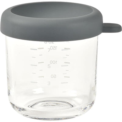 Beaba 8oz glass baby food jar with a gray silicone lid and measurement markings on the side.