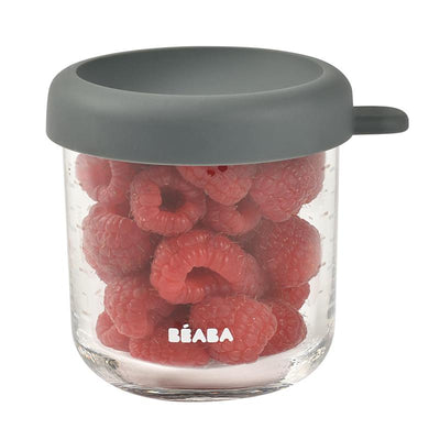 Beaba 8oz glass baby food jar filled with fresh raspberries, featuring a gray silicone lid.