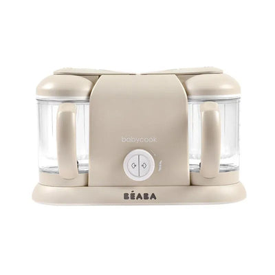 Beaba Babycook Duo in Oat color, featuring two transparent bowls and a control dial for steaming and blending baby food.