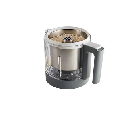 BEABA Rice, Pasta and Grain Pro Insert Food Mill in white, featuring a steel top and transparent bowl with rice inside.