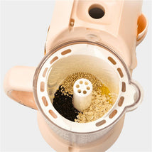 White Beaba Rice, Pasta & Grains Pro Insert food mill with assorted grains and seeds inside, featuring a central grinding tube.