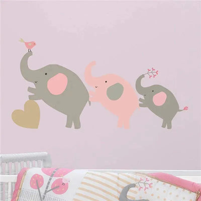 Pink and grey wall decals featuring three playful elephants and a bird, intended for nursery decoration.