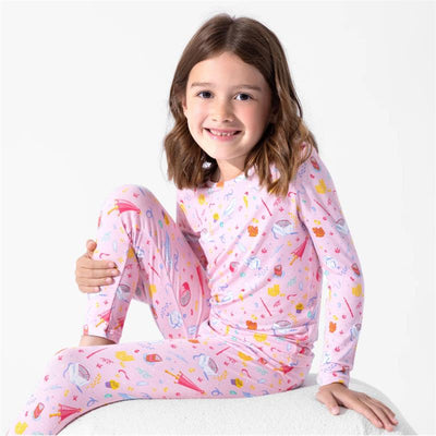 Bamboo pajamas for kids featuring a colorful Harry Potter-themed print, modeled by a smiling girl.
