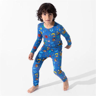 Bamboo kids pajamas featuring colorful Harry Potter-themed designs worn by a boy in a playful stance.