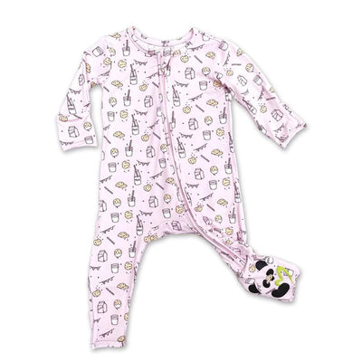 Pink bamboo pajamas for kids featuring a milk and cookies print, with a zip closure and contrasting foot design.