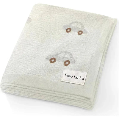 100% luxury cotton receiving swaddle baby blanket in cream with car patterns and a visible Bleu La La label.