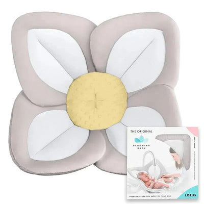 Plush grey baby sink bathtub cushion shaped like a lotus flower, with packaging displaying a mother bathing a baby.
