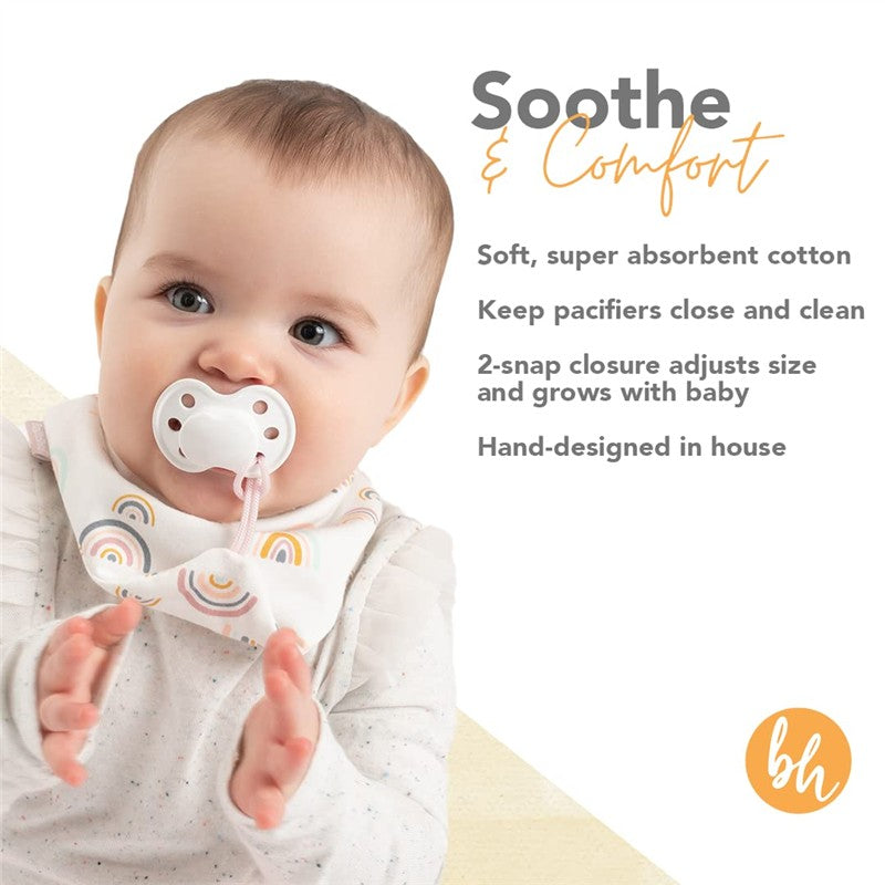 Baby wearing a pink rainbow-patterned bandana pacifier holder bib with a pacifier, showcasing comfort and functionality.