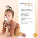 Carrara marble-patterned silicone pacifier clip securely holds a pacifier, shown attached to a baby in casual clothing.