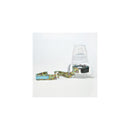 Sippi Grip bottle in grey dots pattern with a strap, designed to prevent drops and spills for toddlers.