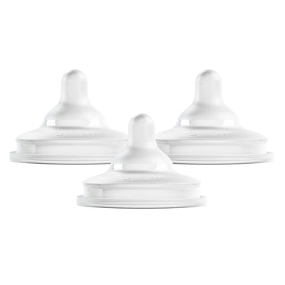 Three white silicone bottle nipples designed for preemie flow, featuring a curved shape for easy feeding.