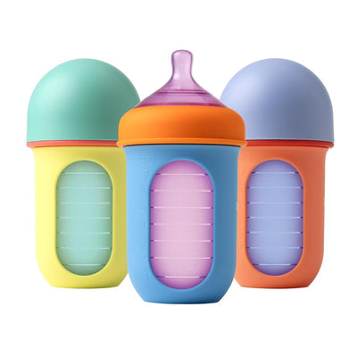 Three Boon 3Pk Nursh silicone baby bottles, 8 oz each, in pastel color block designs with measurement markings.
